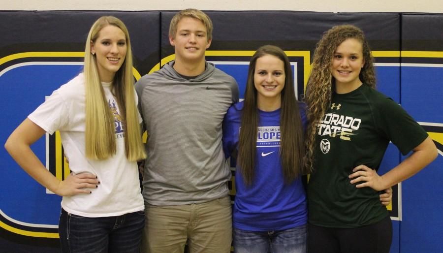 Dawgs, left to right, Josie Cox, Jayden Kruse, Allison Kuenle, and Olivia NIcholson sign with various next-level schools on National Signing Day