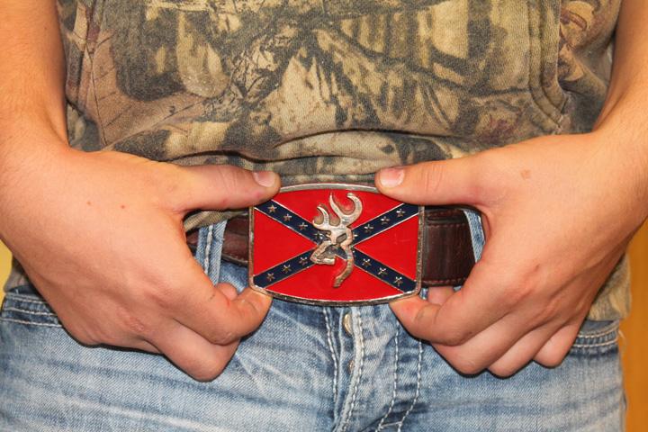 Freshmen Braydon Hanna shows off the Browning/Confederate flag belt buckle he’s worn for several years.  “I think it’s cool,” he said.
