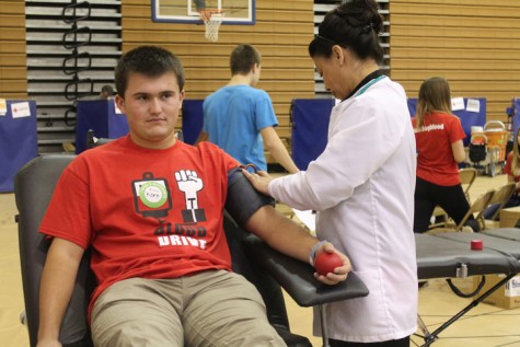 Senior Kort Steele generously giving blood.