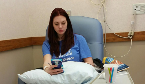 Junior Courtney Pelland occupies herself during her lengthy blood transfusion.