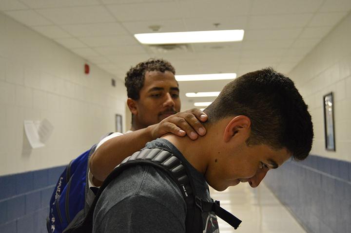 Juniors Braiden Ruffin and Christian Ramos demonstrate a neck. 