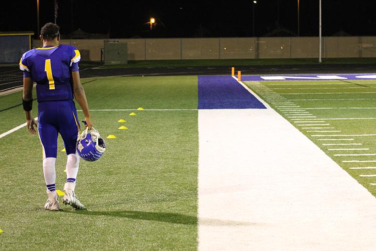 Senior Trevon Weaver stands alone on the sideline during the fourth quarter of the Bulldogs 59-12 victory against Omaha Bryan. 