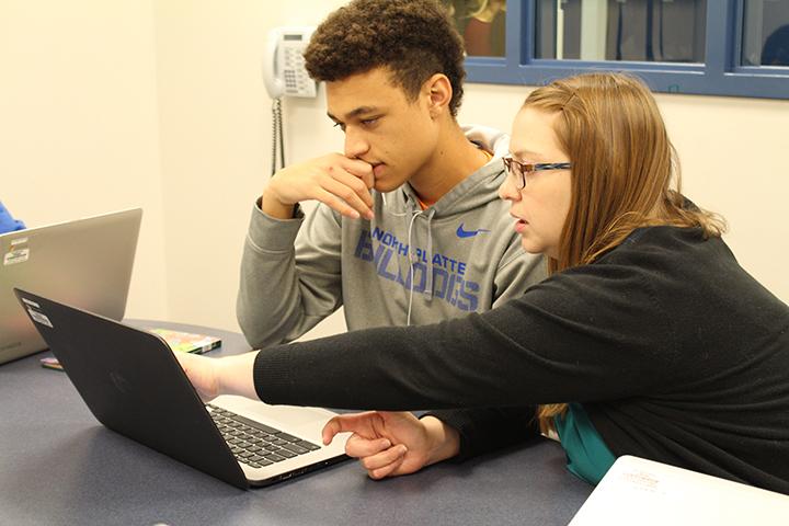 Junior Zavion Mictchell getting help from English teacher Sarah Snively in the newly established learning labs. These labs, as well as NHS tutoring in the mornings, provide extra help to students who are struggling in class. 