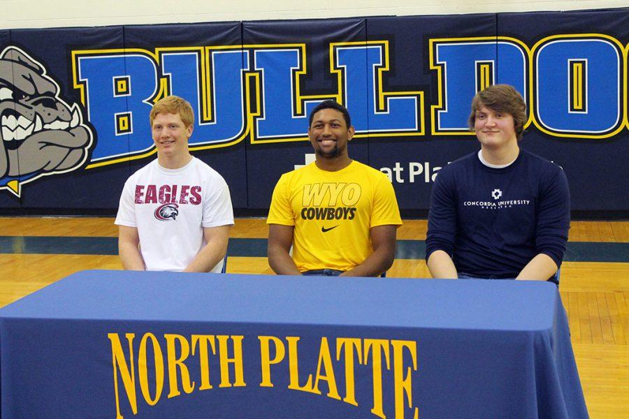 Seniors Jayden Songster, Trevon Weaver, and Cade DiGiovanni pose for pictures on National Signing Day after they officially made their collegiate sports commitments Wednesday at North Platte High School.