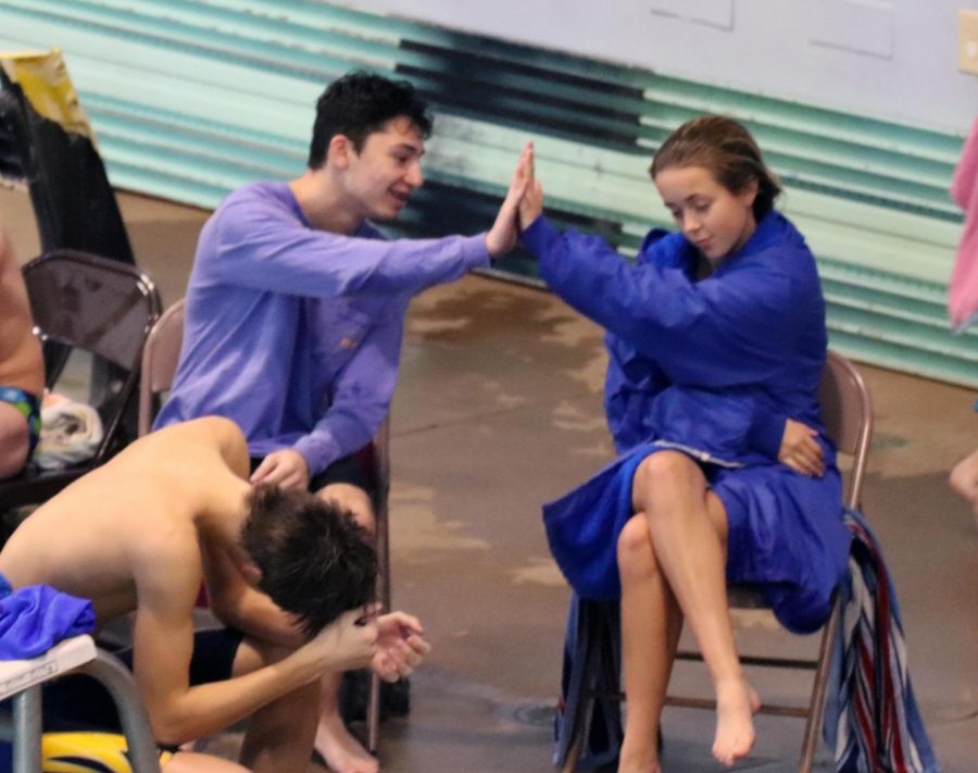 Senior Miles Sweeney and junior Riley Smith high-five during the Hastings Swim & Dive Invitational diving competition on Dec. 2, 2017. 