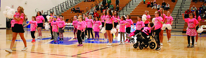 The NPHS cheerleaders perform with their elementary cheer clinic at halftime.