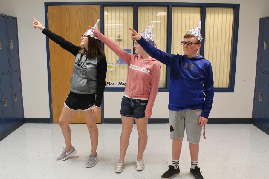 Freshmen Bubba Nelson, Emmalynn Berry, and Jorey Skinner protecting their brains from aliens as they wait for the world to end. I feel it could be a good and a bad thing, said Nelson when asked his thoughts on the end of the world. It depends on what you believe in, it could be a good way to restart.
