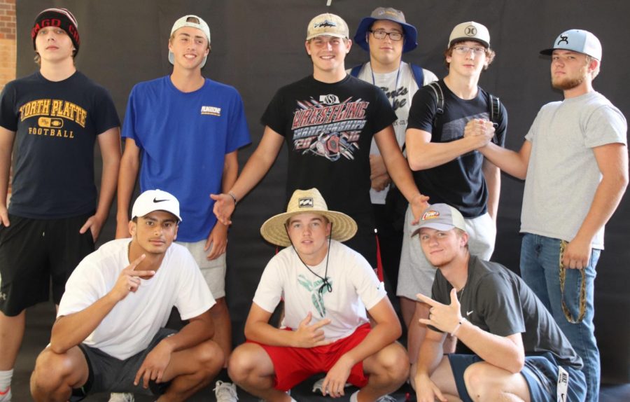 Seniors Drew Phillips, Max Hayes, Keifer Smitty, Jake Johnson, Zach Kring, Brycen Tophane, Jonathan Edwards, Jacob Tobey, and sophomore Callen Zurn pose in their unofficial homecoming theme hats. 