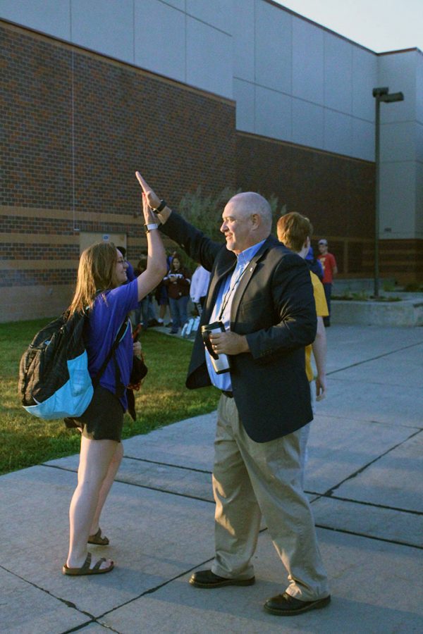 Assistant principal John Byrn gives a high-five to senior Haley Ablard on High-Five Friday. “I try to get all of [the students], but a couple of them sneak by, and that’s okay.” Byrn said. 