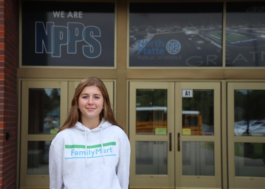 Junior Isabella Whitney poses for a photo in front of NPHS.