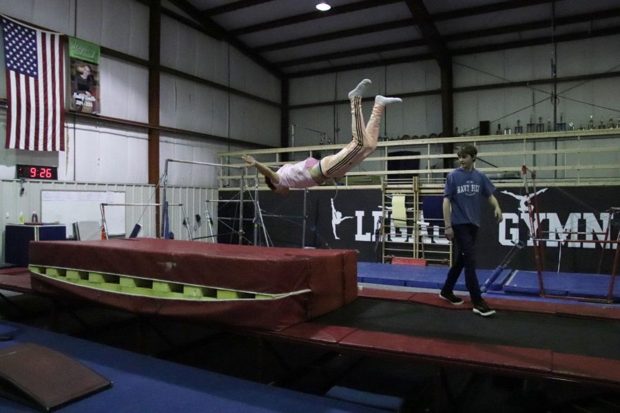 Jackson Erickson does a warm up flop onto a mat at Legacy Dance and Gymnastics on Nov. 1. Legacy has recently started to host an open gym at their studio every other Friday thats available to anyone.