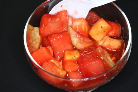 A close up of the mexican fruit cup with chamoy and tajin.