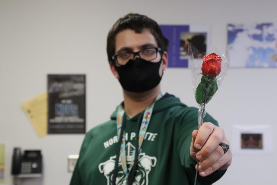 Arts and Entertainment editor Nathenial Crow poses with a rose. 