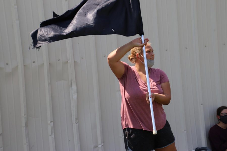 Sophomore Anastazia Weir at color guard practice at the beginning of the season, learning a new move without a coach.
