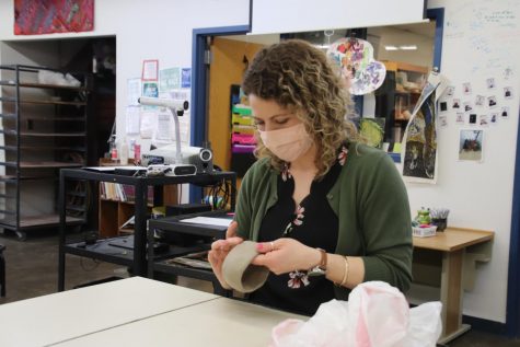 Joy DeVoe demonstrates how to create a pinch pot for her art class.