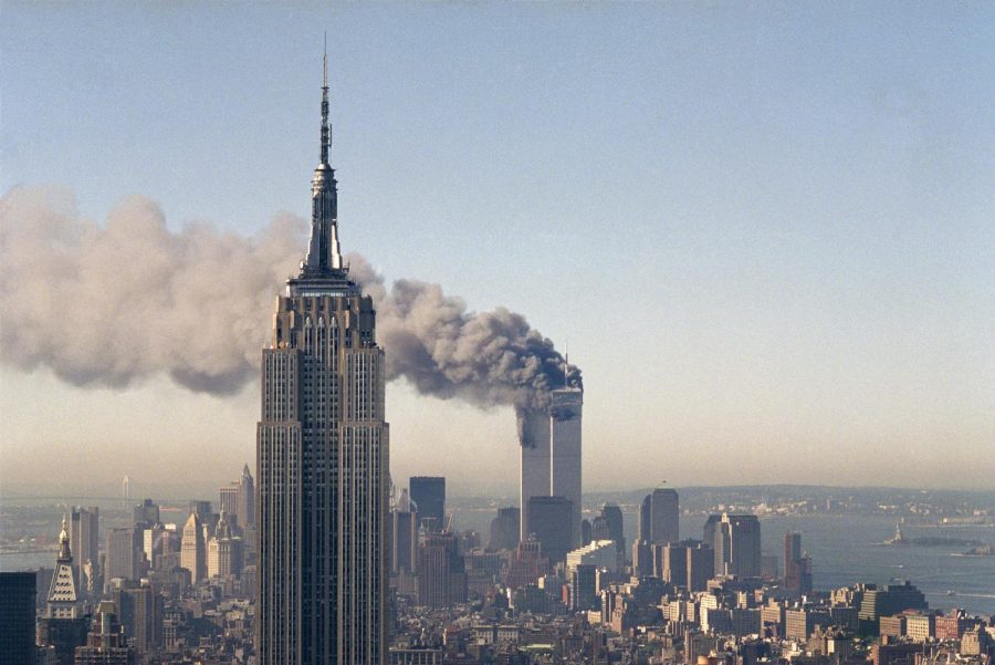 The+twin+towers+of+the+World+Trade+Center+burn+behind+the+Empire+State+Building+in+New+York%2C+Sept.+11%2C+2001.+In+a+horrific+sequence+of+destruction%2C+terrorists+crashed+two+planes+into+the+World+Trade+Center+causing+the+twin+110-story+towers+to+collapse.