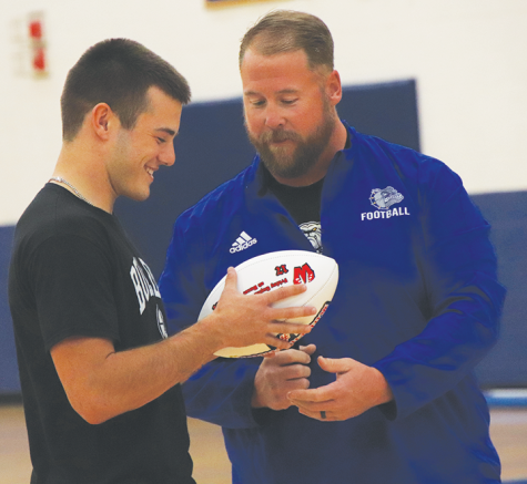 Coach Altig presents Kolten Tilford the Westside game ball at the fall pep rally on Oct. 20.