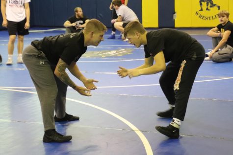 Junior Jace Kennel, right, and assistant wrestling coach Rory Little wrestle during an open mat day in November.