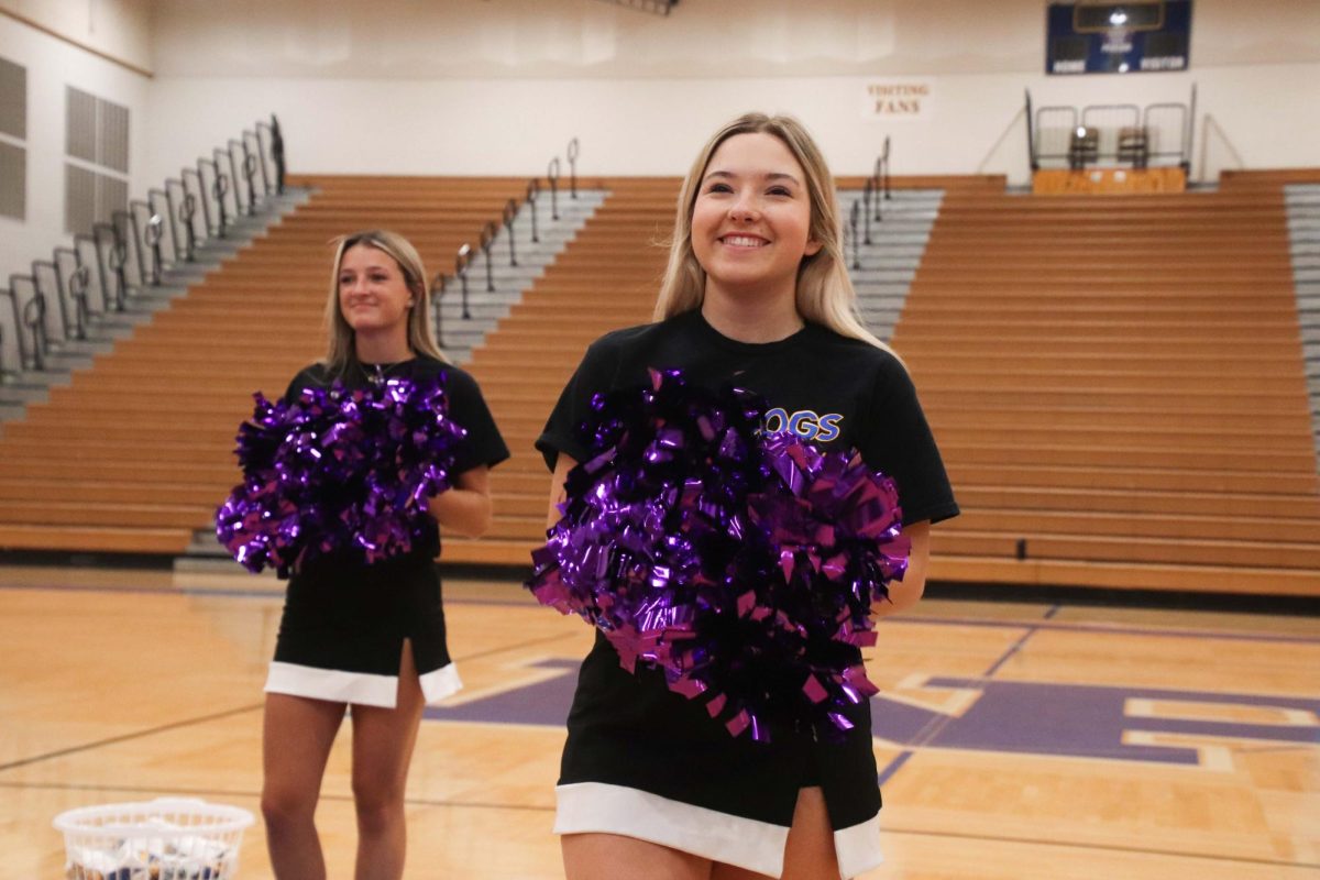 Cheerleaders Jaleigh Comer and Faith Morris pump up students at the pep rally on Sept. 18.
