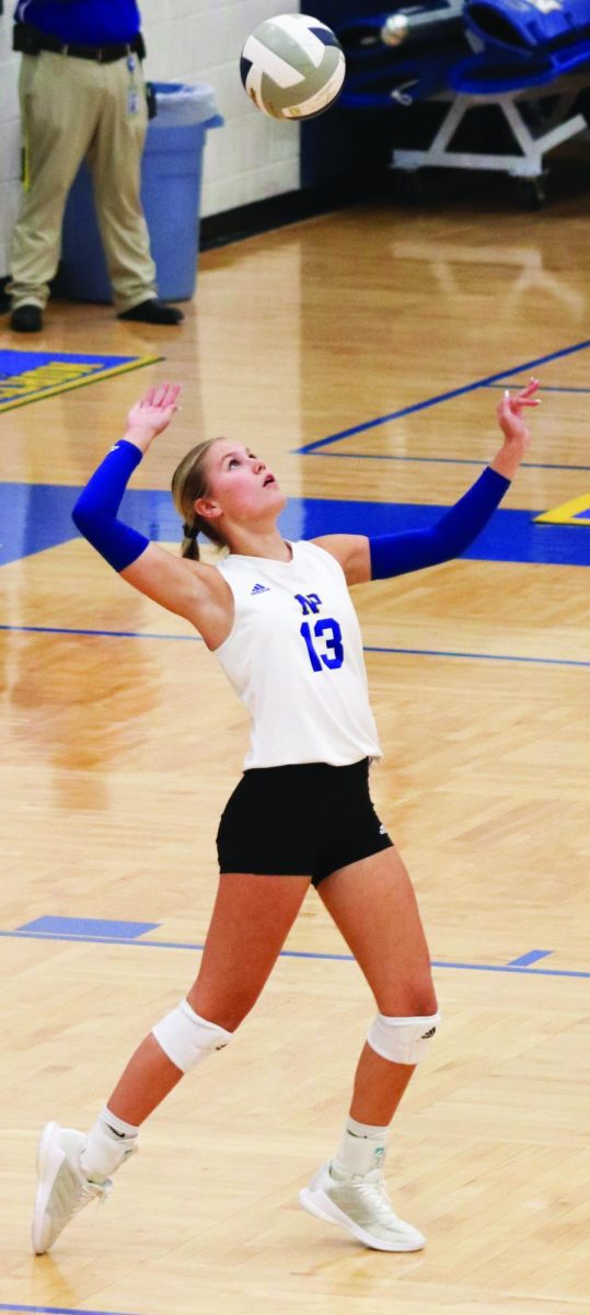 Abby Kaminski serves against Grand Island Central Catholic in the Dawg Pound on Oct. 3. “I have to ignore all the people in the stands and focus on the ball (when I serve),” Kaminski said.