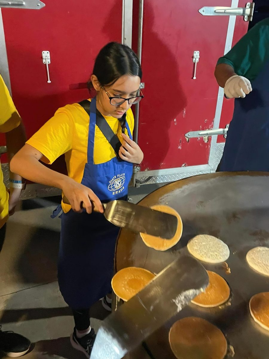 Lizeth Rodriguez-Sanchez flips a pancake at the pancake feed. 