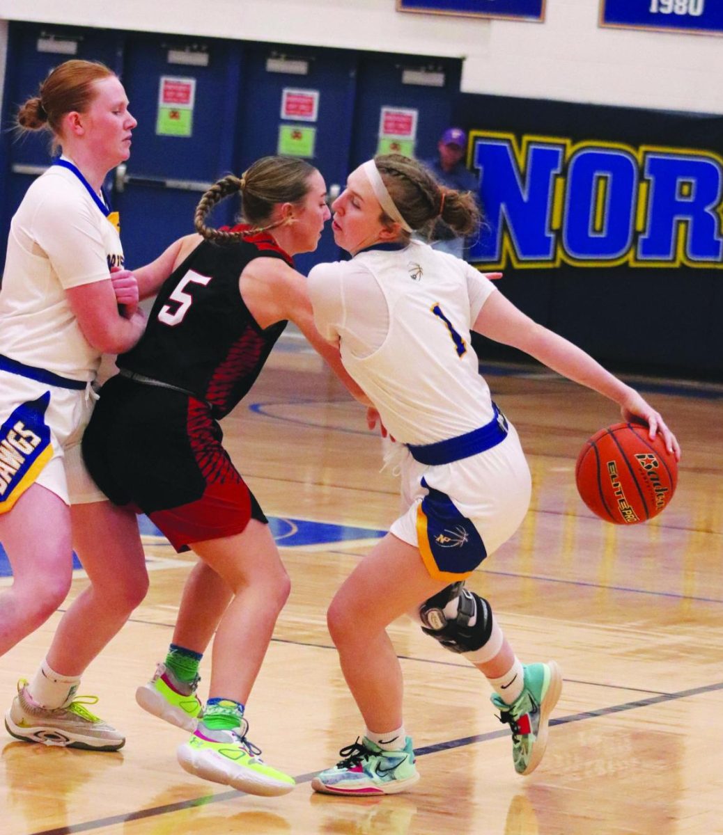 Senior Clancy Brown dribbles the ball around her back at a home game against McCook on Jan. 19 in the Dawg Pound.  