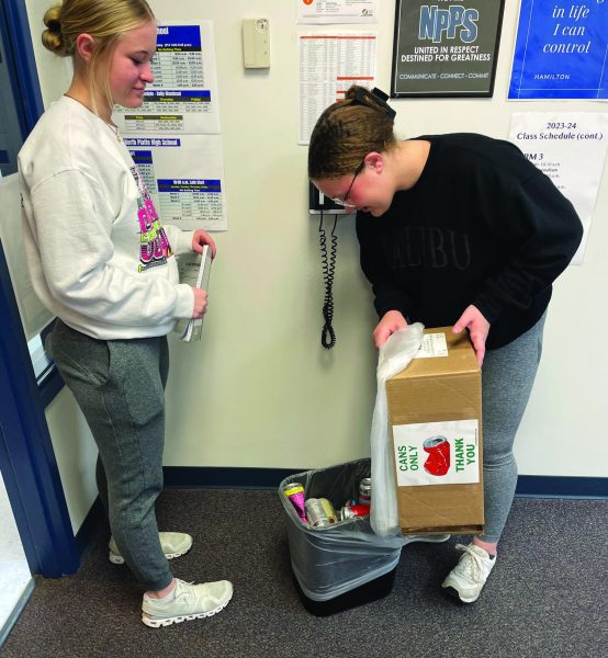 Sophomores Maleighya Harmon and Lauren Bowers collect cans from a classroom on Feb. 1.